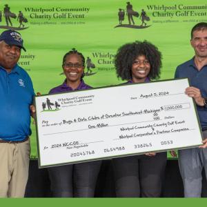 5 people holding up a big check