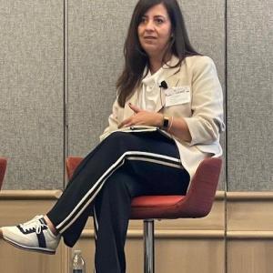 One person sitting on a chair talking