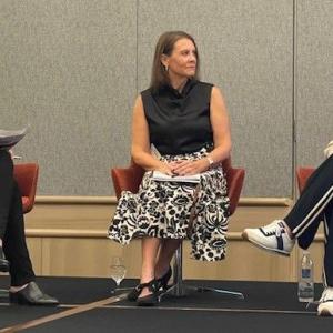 Three people sitting on chairs looking at each other