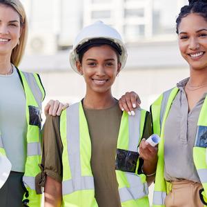 Women in construction. Three women shown wearing hardhats and construction vests.