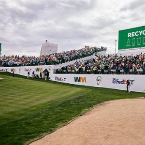People sat watching a golf tournament