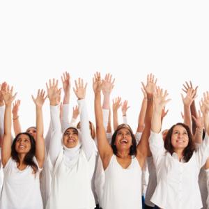 group of people all wearing white shirts, arms raised up