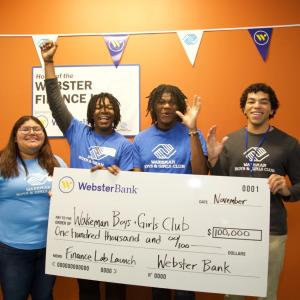 Group celebrating with oversized check
