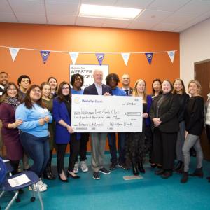 Group celebrating with oversized check