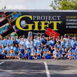 Group photo in front of Project GIFT trailer