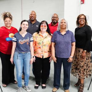  A group of people in between two informational boards.