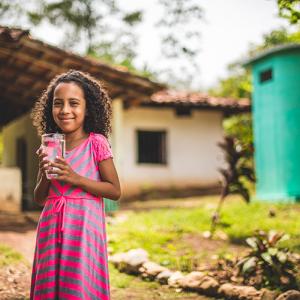 Little girl with glass of water