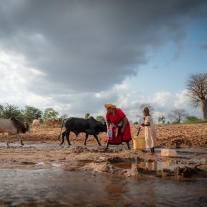 Celestine and her grandmother carrying water