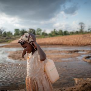 Celestine and her grandmother carrying water