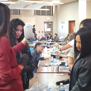 Students building water filters in a classroom setting.