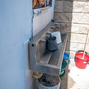 Sink with buckets lined up