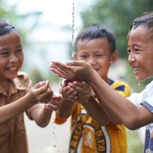 Children catching water in their hands