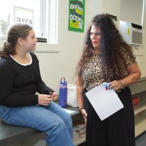 Photo: Representative from Stamford High School, CT, speaks with a student.