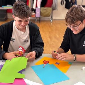 Teenagers shown doing an art project.