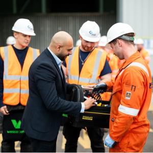 Zubi shaking hands with the apprentices.
