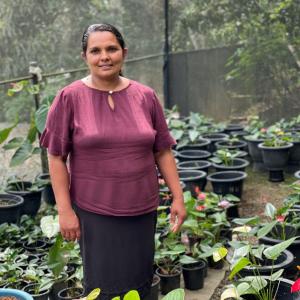 Widya with lots of potted plants
