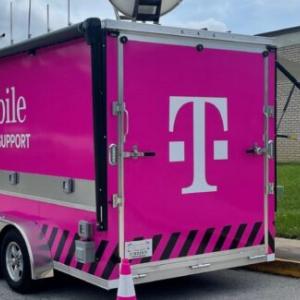 pink TMobile trailer a large satellite dish on top