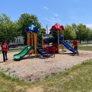 KeyBank volunteers cleaning up a playground.