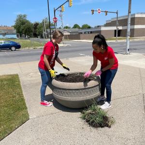 KeyBank volunteers cleaning a planter.