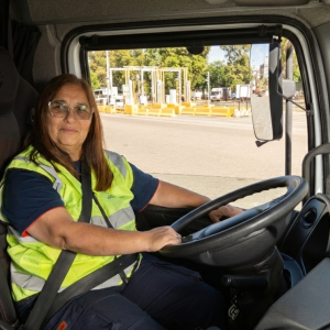 Female truck driver wearing a high-visibility vest operates a truck at DP World’s Buenos Aires terminal.