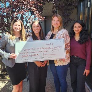 Four women shown holding a grant check from Saint-Gobain for $21,098.