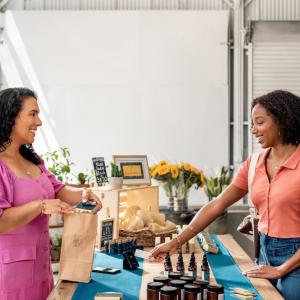 A women owned business and a customer are shown.