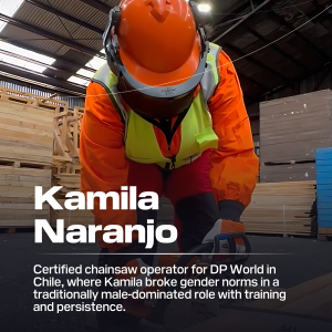 Kamila Naranjo wearing an orange work suit while building with lumber