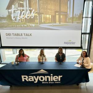 Four women sat at a large table 