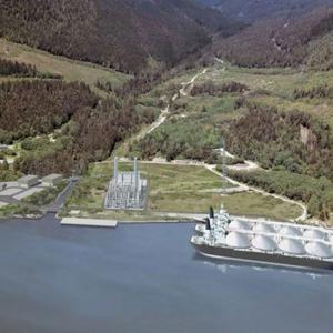 Aerial rendered image of a forested valley with a plant near waters' edge and a large boat