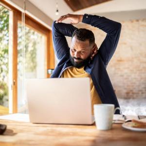 Man Stretching at Desk