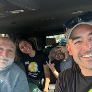 Mike Bean in a van with other volunteers