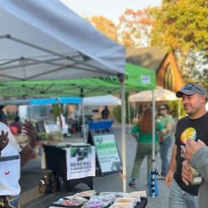 volunteers talking outside under a tent