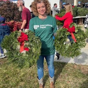 person holding up wreaths