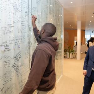 A person writing on a white board