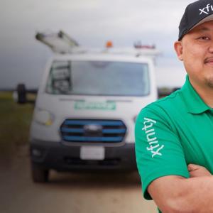 Person wearing a Xfinity t-shirt stood in front of a van