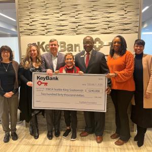 Team members from the YWCA Seattle and KeyBank shown with a $240,000 grant check.