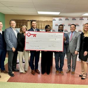 KeyBank leadership and YWCA of Rochester representatives receiving a $200,000. grant check.