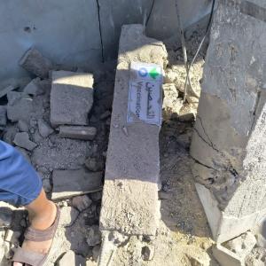 A man walks across a floor piled with rubble