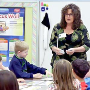 Yolanda Hollingsworth standing in front of a class of students.