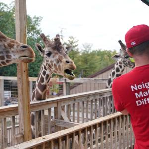 Family with an infant visiting the zoo.