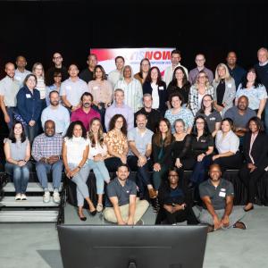Group of people posing on stage