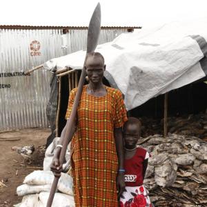 A woman and her child in front of a fish shop in rural Sudan