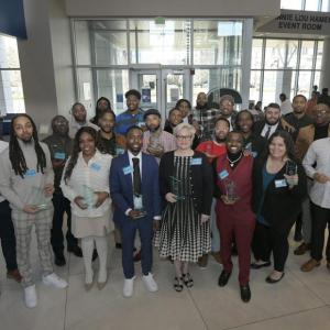 A large group of people holding awards