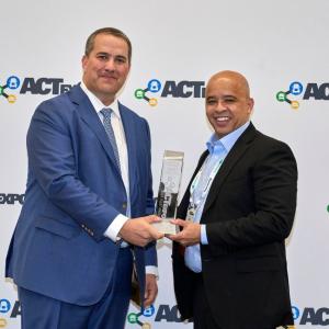 Dan Purefoy accepting an award from another.