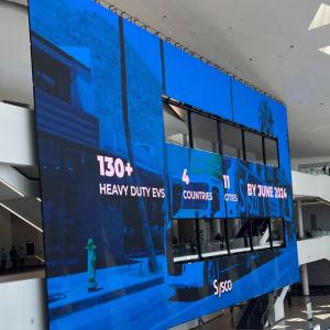 A large display with statistics and Sysco logo.