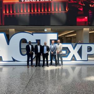 Five people posed with an award in front of a large "ACTExpo" sign.