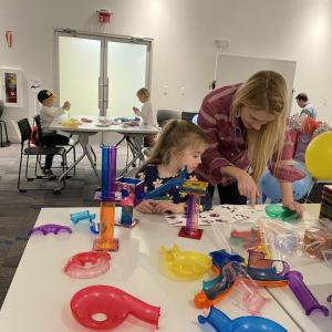 adult and child participating in science experiments and activities