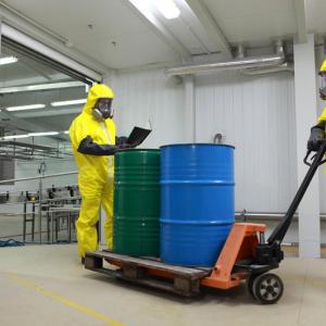 Workers in PPE transport chemicals in a warehouse