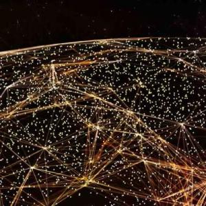 Aerial view of a dark globe in space. Golden lights and lines connecting them covering the surface.