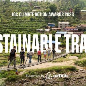 "Sustainable Travel" and Air bnb logo. People crossing a narrow bridge in a mountain terrain.